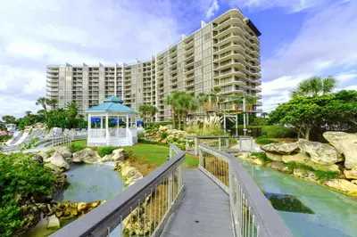 a resort with a bridge over a river with a gazebo at Edgewater Tower 2-611 in Panama City Beach