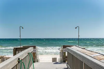 a wooden pier with the ocean in the background at Sunrise Beach #910 in Panama City Beach