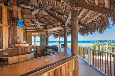 a porch of a resort with the beach in the background at Calypso 1-608 East in Panama City Beach