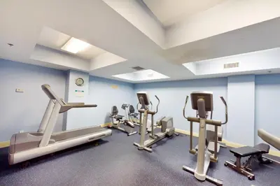 a gym with several tread machines in a room at Calypso 1-608 East in Panama City Beach
