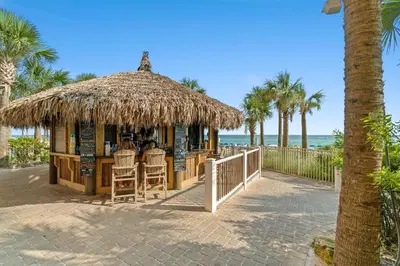 aiki bar on the beach with palm trees and the ocean at Calypso Beach Resort in Panama City Beach