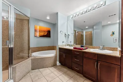 a bathroom with two sinks and a shower at Laketown Wharf Remodeled Gulf View Retreat! 3BR Resort Condo with Huge Balcony in Panama City Beach