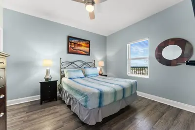 a bedroom with a bed and a window at Laketown Wharf Remodeled Gulf View Retreat! 3BR Resort Condo with Huge Balcony in Panama City Beach