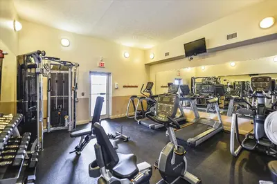 a gym with several treadmills and exercise bikes at Treasure Island 0510 in Panama City Beach