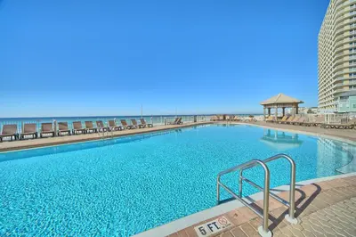 a large swimming pool with the beach in the background at Treasure Island 0506 in Panama City Beach