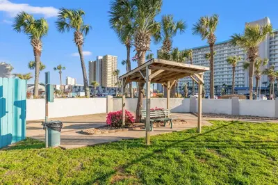 a park with a bench and palm trees at The Summit 1409 in Panama City Beach
