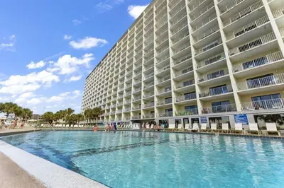 a large building with a swimming pool in front of it at The Summit 728 in Panama City Beach