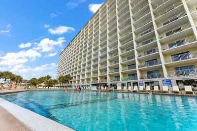 a swimming pool in front of a large building at The Summit 504 in Panama City Beach