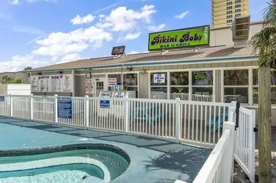 a restaurant with a pool in front of a building at The Summit 1017 in Panama City Beach
