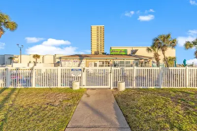 a white fence in front of a building at The Summit 1217 in Panama City Beach