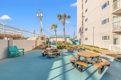 a group of tables and benches on a patio at The Summit 1217 in Panama City Beach