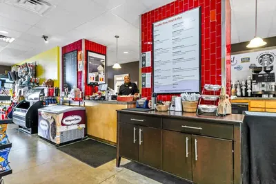 a man standing behind the counter of a restaurant at Majestic Beach Towers 2-403 in Panama City Beach