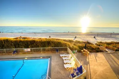 a view of the beach with a swimming pool and the ocean at Sea Glass Villa in Panama City Beach