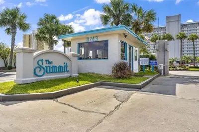 a building with a sign that reads the summit at The Summit 621 in Panama City Beach