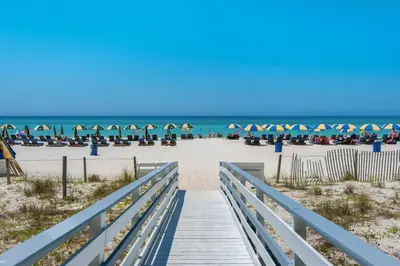 a boardwalk to the beach with the ocean in the background at Twin Palms 1201 in Panama City Beach