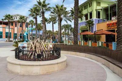 a statue of baseball bats in a basket on a city street at Sugar Beach C-17 (2/2) in Panama City Beach
