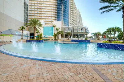 a large swimming pool in a city with tall buildings at Laketown Wharf 734 By Aneliya in Panama City Beach