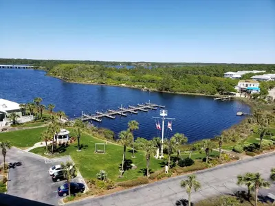 an aerial view of a lake with a dock at Pinnacle Port Beach Resort in Panama City Beach