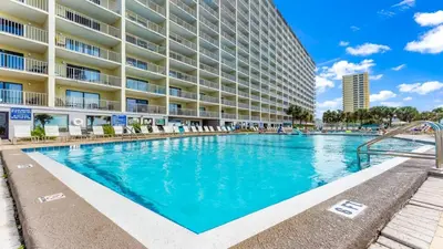 a swimming pool in front of a large apartment building at The Summit 1116 in Panama City Beach