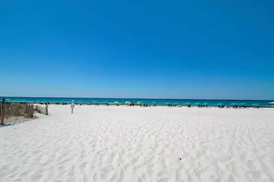 a white beach with a bunch of people on it at Beachside Villas 332 in Santa Rosa Beach