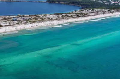 an aerial view of a beach with people in the water at Beachside Villas 332 in Santa Rosa Beach