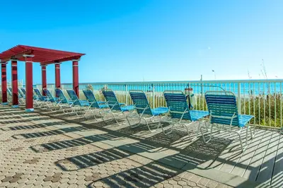 a row of chairs sitting on the beach at Majestic Beach Towers 2-1206 in Panama City Beach