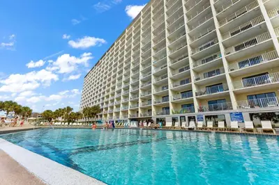a swimming pool in front of a large building at The Summit 506 in Panama City Beach