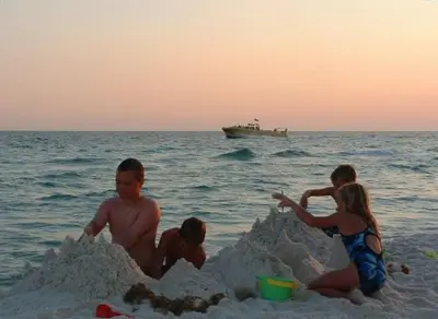 a group of people playing in a sand castle on the beach at Edgewater W404 'Sandpiper' in Panama City Beach