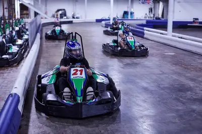 a child riding in a race car on a track at Mariner West 606 'Beach Happy' in Panama City Beach
