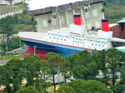 a large cruise ship parked next to a building at Edgewater 3-0413 'Once Upon A Tide' in Panama City Beach