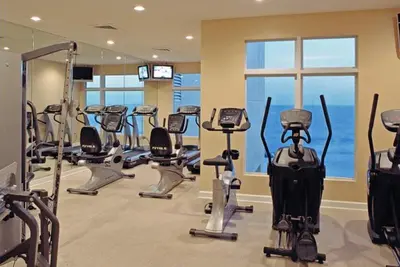 a gym with several treadmills and exercise bikes at Sterling Reef 802 in Panama City Beach