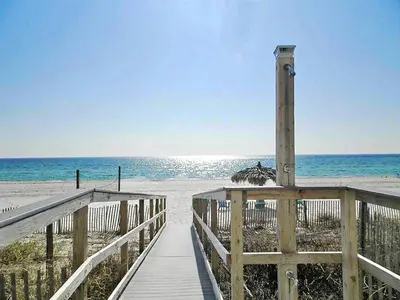 a wooden walkway to the beach with the ocean at Grandview East 1004 in Panama City Beach