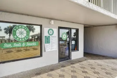 a store with a sign on the side of a building at The Summit 220 in Panama City Beach