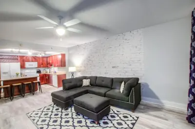 a living room with a couch and a kitchen at BRAND NEW!Laketown Wharf 334! Beautiful 3 BD, Great Amenities, And Great Location in Panama City Beach