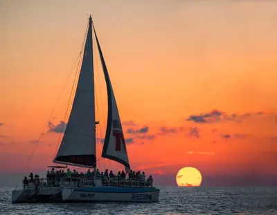 a group of people on a sailboat at sunset at Hidden Dunes 1603 in Panama City Beach