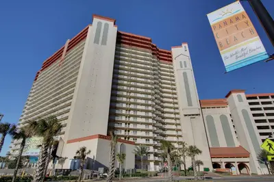 a large building with palm trees in front of it at Shores of Panama #2201 by Book That Condo in Panama City Beach
