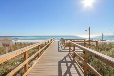 a wooden boardwalk leading to the beach at Majestic Beach Resort #1215-1 by Book That Condo in Panama City Beach
