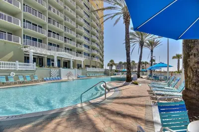 a swimming pool at a resort with chairs and a hotel at Boardwalk Beach Resort #1703 by Book That Condo in Panama City Beach