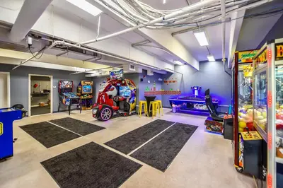 a childrens room with a game room with a arcade at Emerald Beach #636 by Book That Condo in Panama City Beach