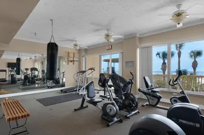 a gym with exercise equipment and a large window at Hidden Dunes 402 in Panama City Beach