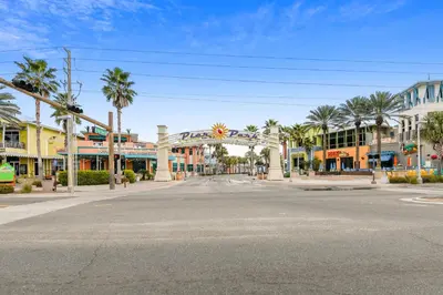 an empty street in a town with palm trees at Emerald Beach #1426 by Book That Condo in Panama City Beach