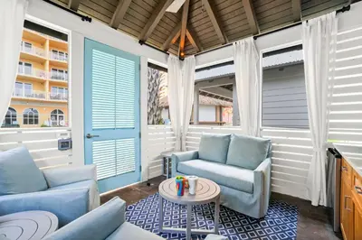 a living room with two chairs and a table at Calypso Beach Resort Tower 3 Rentals in Panama City Beach
