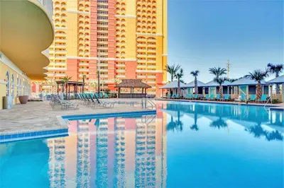 a large swimming pool in front of a large building at Calypso Beach Resort Tower 3 Rentals in Panama City Beach