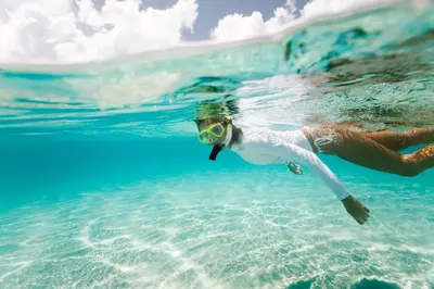 a woman swimming in the water in the ocean at Rollin Tide Villas- Rollin Tide B9 in Santa Rosa Beach