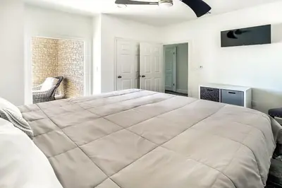 a large white bed in a room with a window at Ocean Air Upper West Private Beach Unit on 30A in Santa Rosa Beach