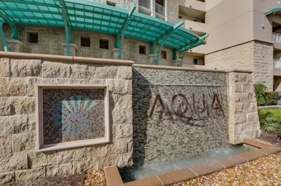 a wall with the word now painted on it in front of a building at Aqua Resort 1705 in Panama City Beach