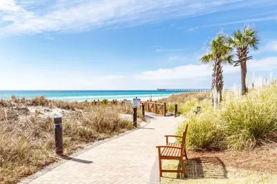 a bench on a path to the beach at Grand Panama 1-1401 in Panama City Beach