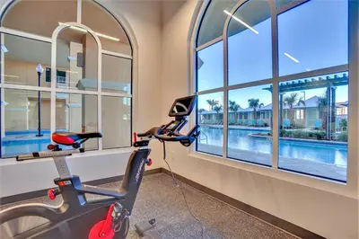 a room with windows and a moped and a swimming pool at Calypso Resort Tower 3 in Panama City Beach