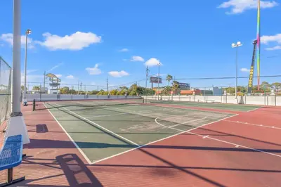 a tennis court with two people on it at The Summit 1208 in Panama City Beach