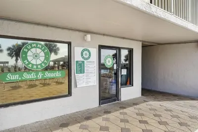 a store with a sign on the side of a building at The Summit 613 in Panama City Beach